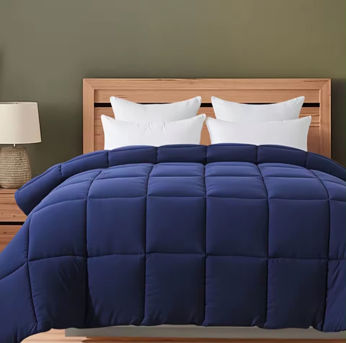 Navy blue comforter styled on bed