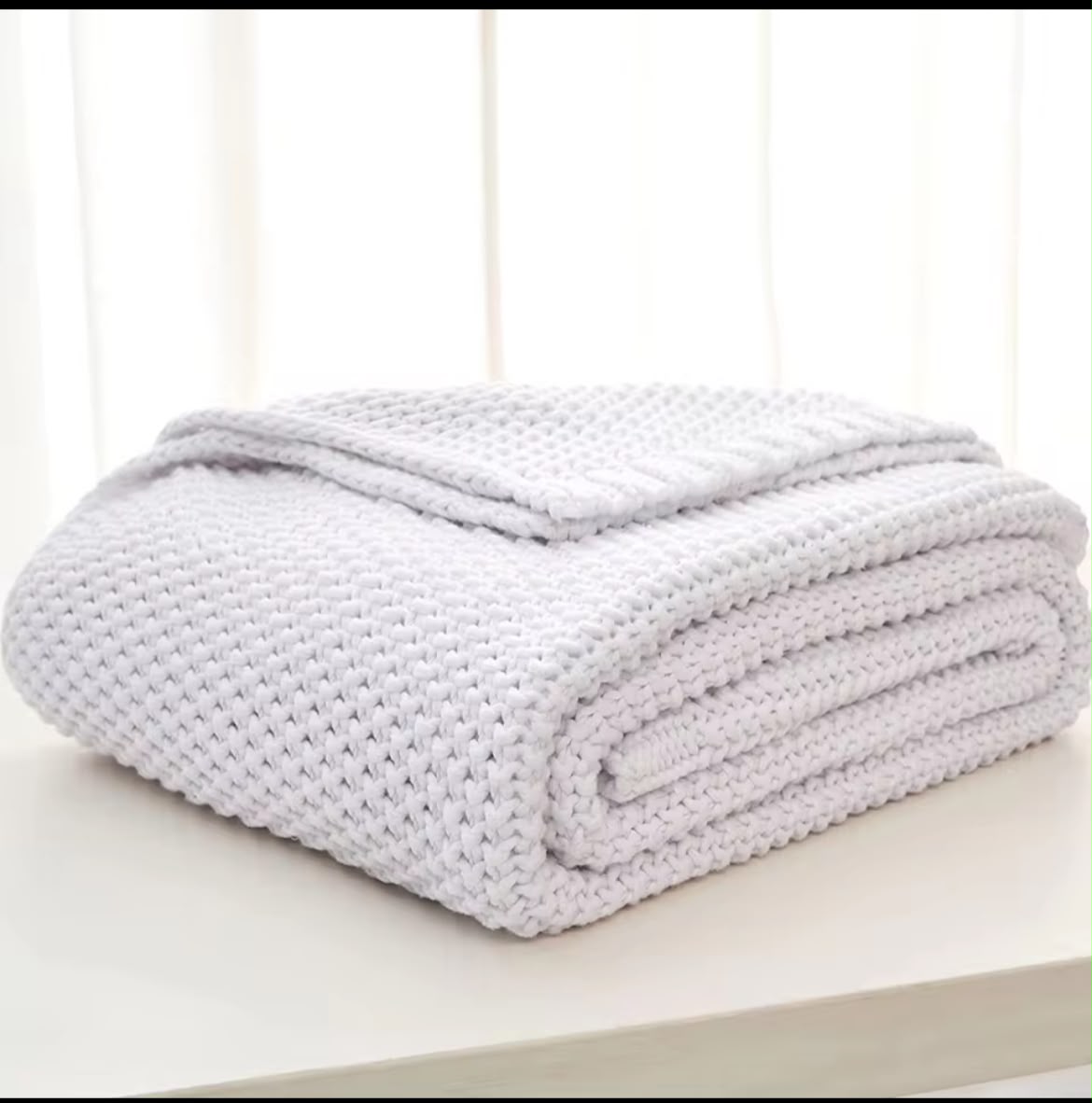 Close-up chunky knit texture olive green throw blanket
