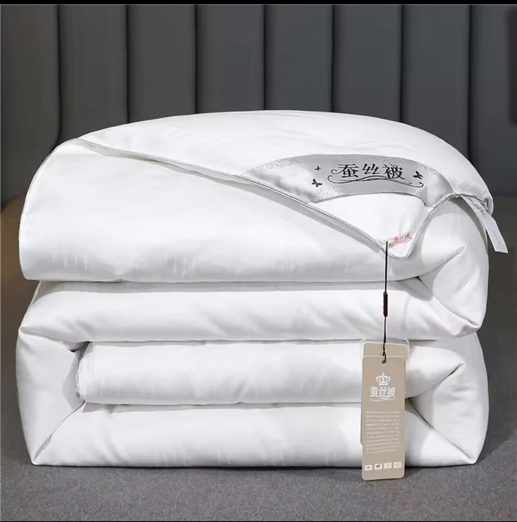 Luxury mulberry silk duvet folded in white with satin label