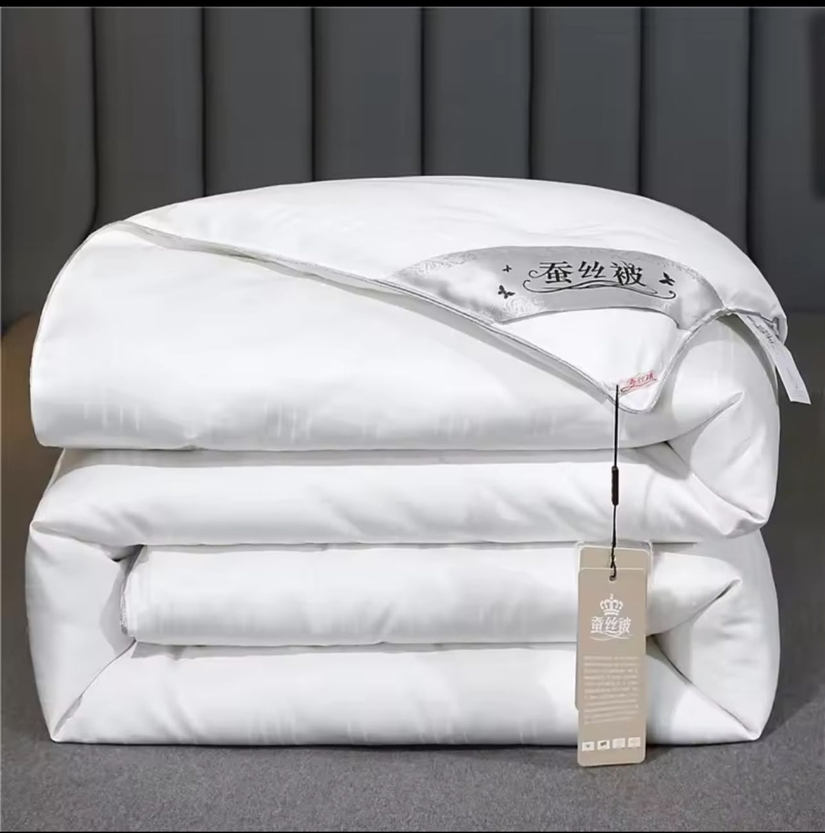Luxury mulberry silk duvet folded in white with satin label