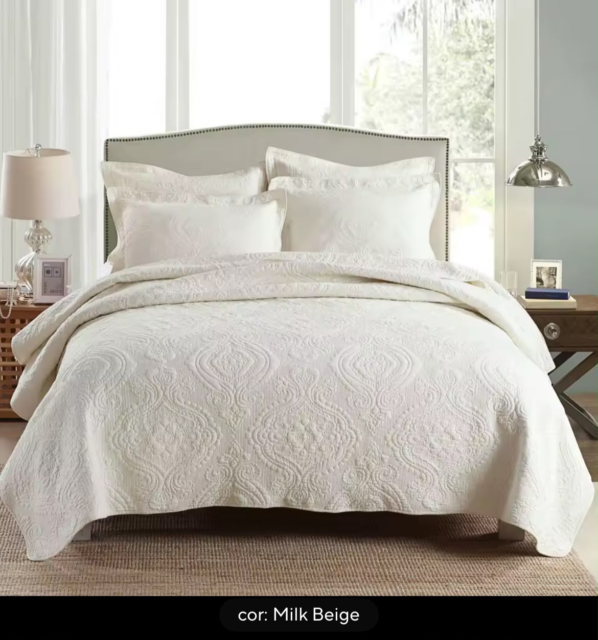 Close-up of white cotton matelassé bedspread raised damask texture with fragrance diffuser