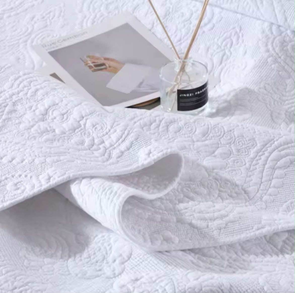 White cotton matelassé pillowcase close-up with decorative detail