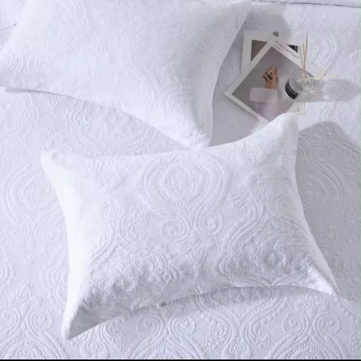 White cotton matelassé bedspread full bed view with matching pillowcases