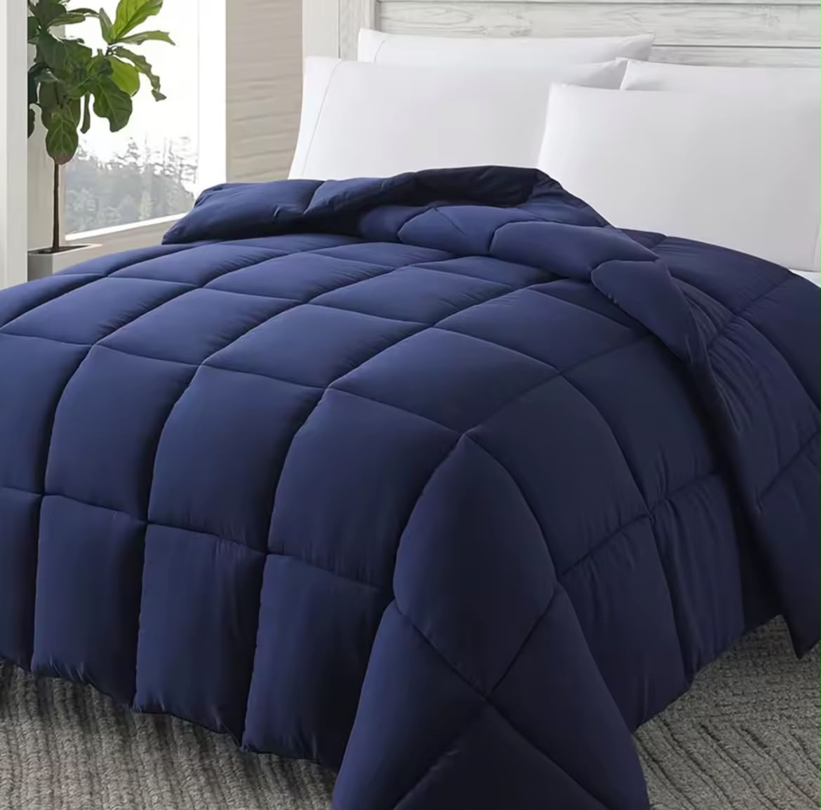 Navy blue down alternative comforter on bed
