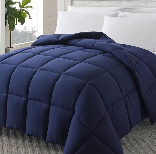 Navy blue down alternative comforter on bed