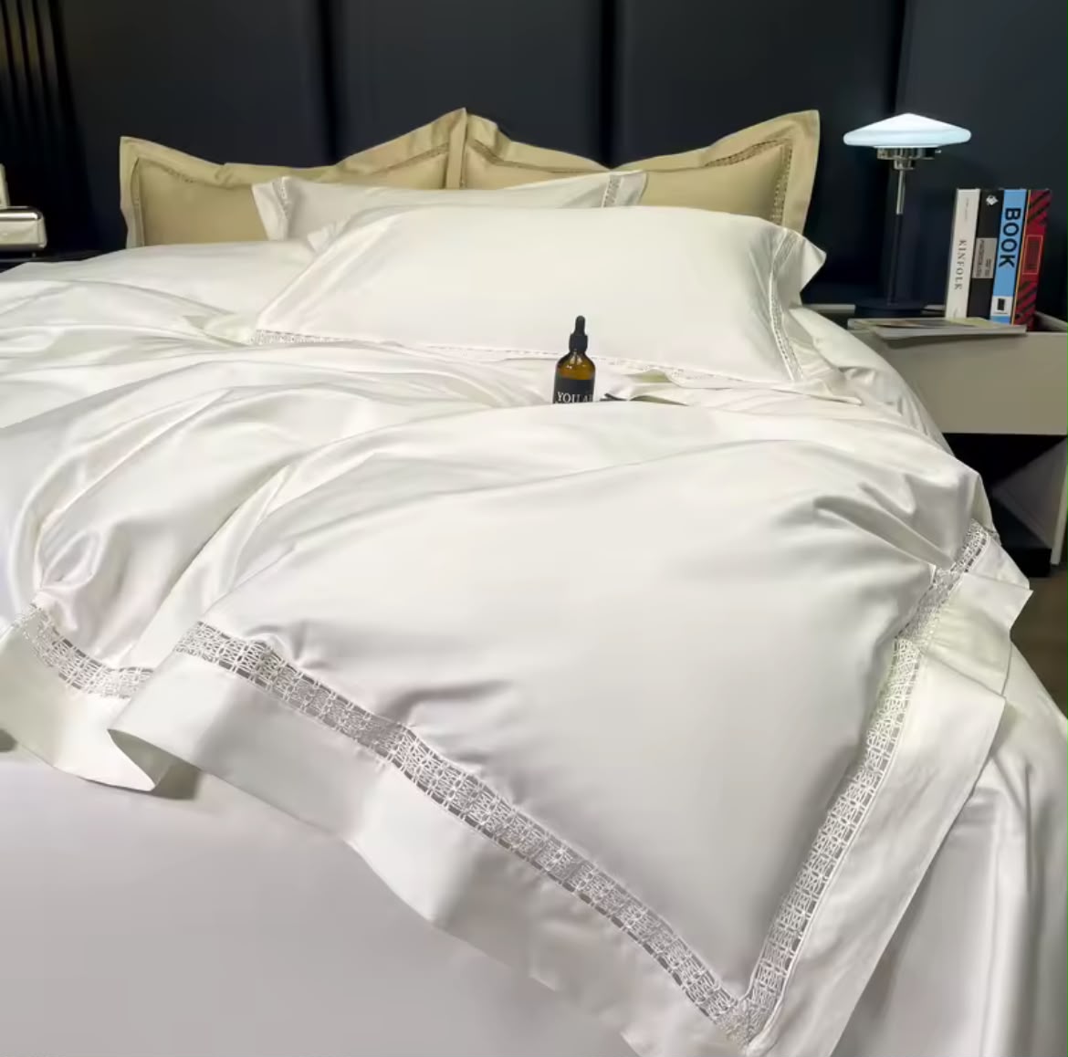 Luxury white Egyptian cotton bedding set with lace border detail on elegant bed