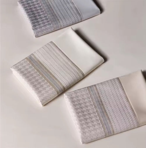 Folded Egyptian cotton 1000TC duvet covers in silver grey, champagne beige and white – top view