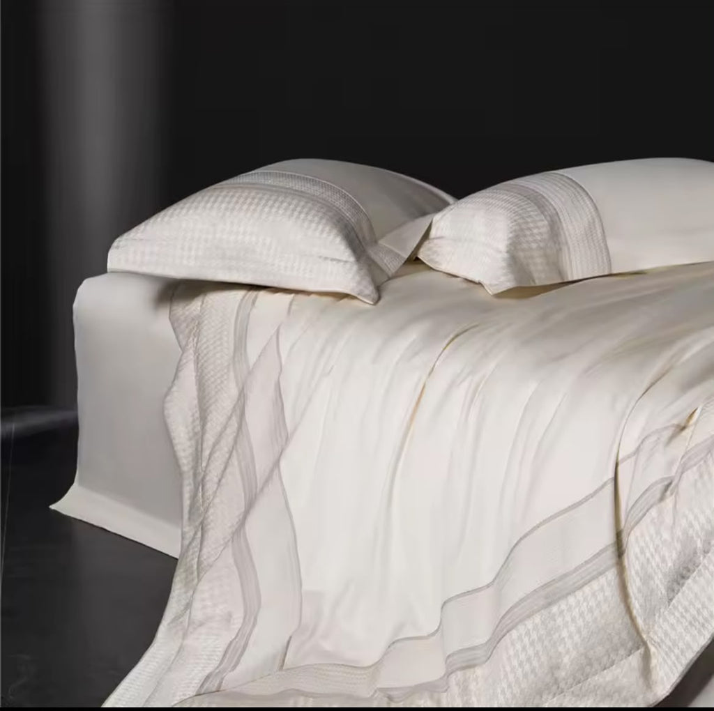 Ivory Egyptian cotton 1000TC duvet cover casually draped over bed end – lifestyle view