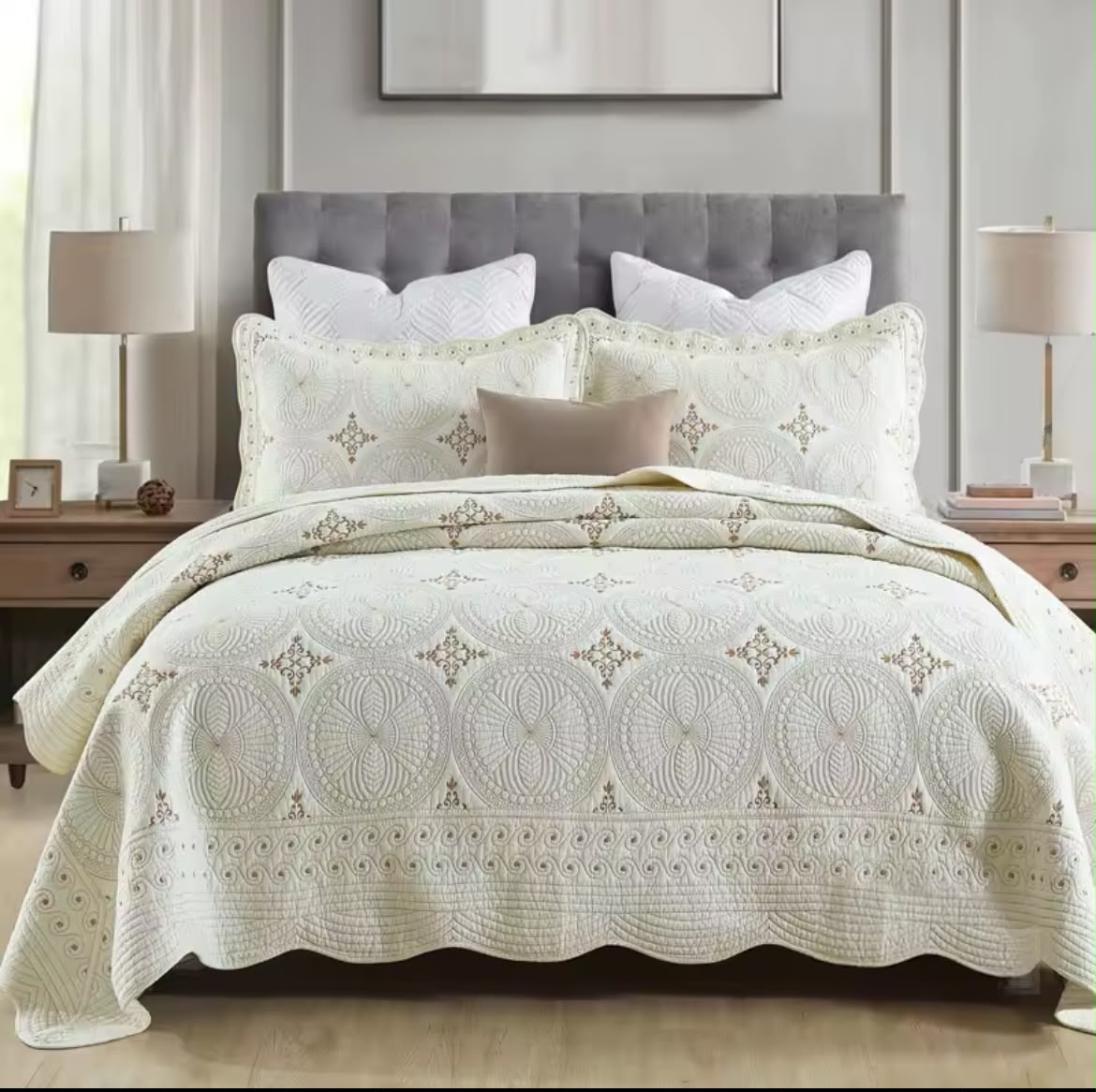 Close-up of ivory cotton embroidered bedspread with gold thread circular mandala pattern