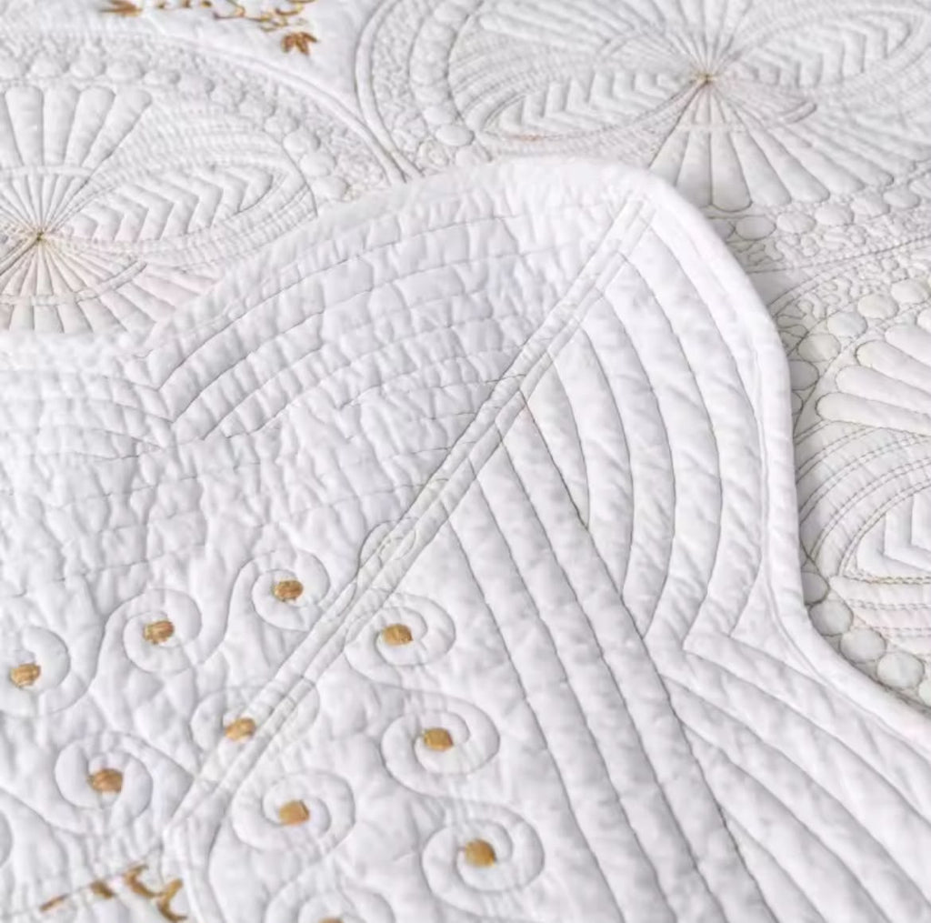 Cream embroidered cotton bedspread set with pillowcases on bed beige headboard