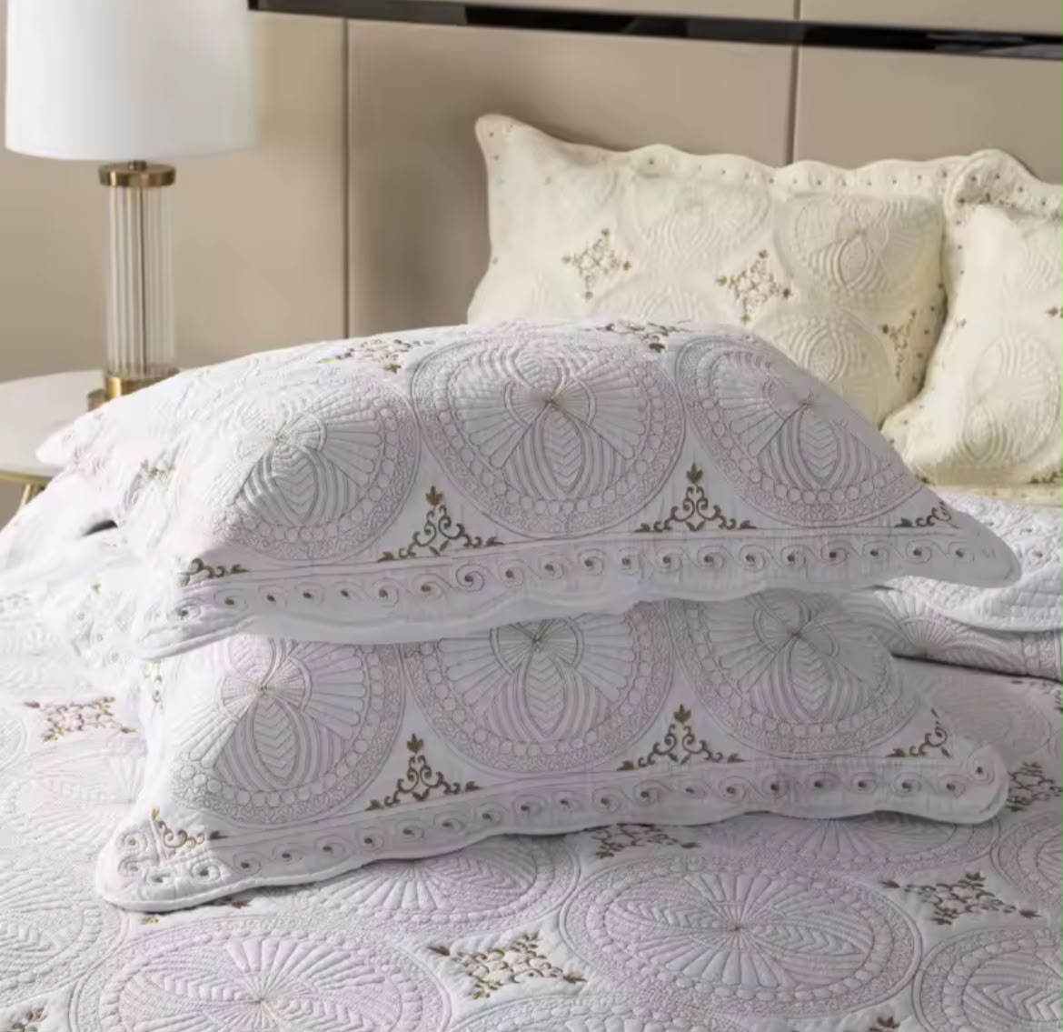 Full bed view cream cotton embroidered bedspread set with gold accent lamp