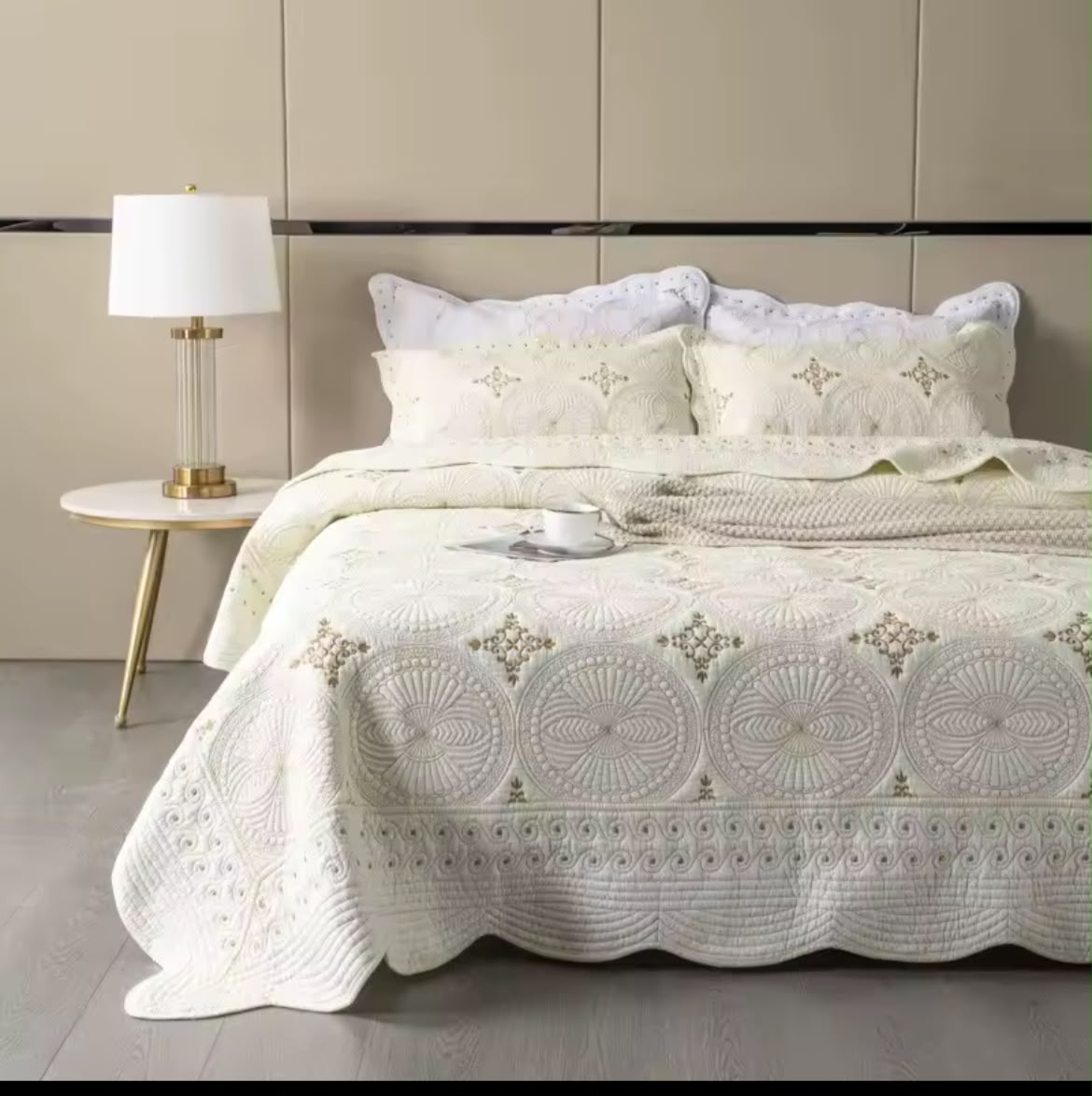Full bed view white cotton embroidered bedspread set with gold floor lamp elegant bedroom