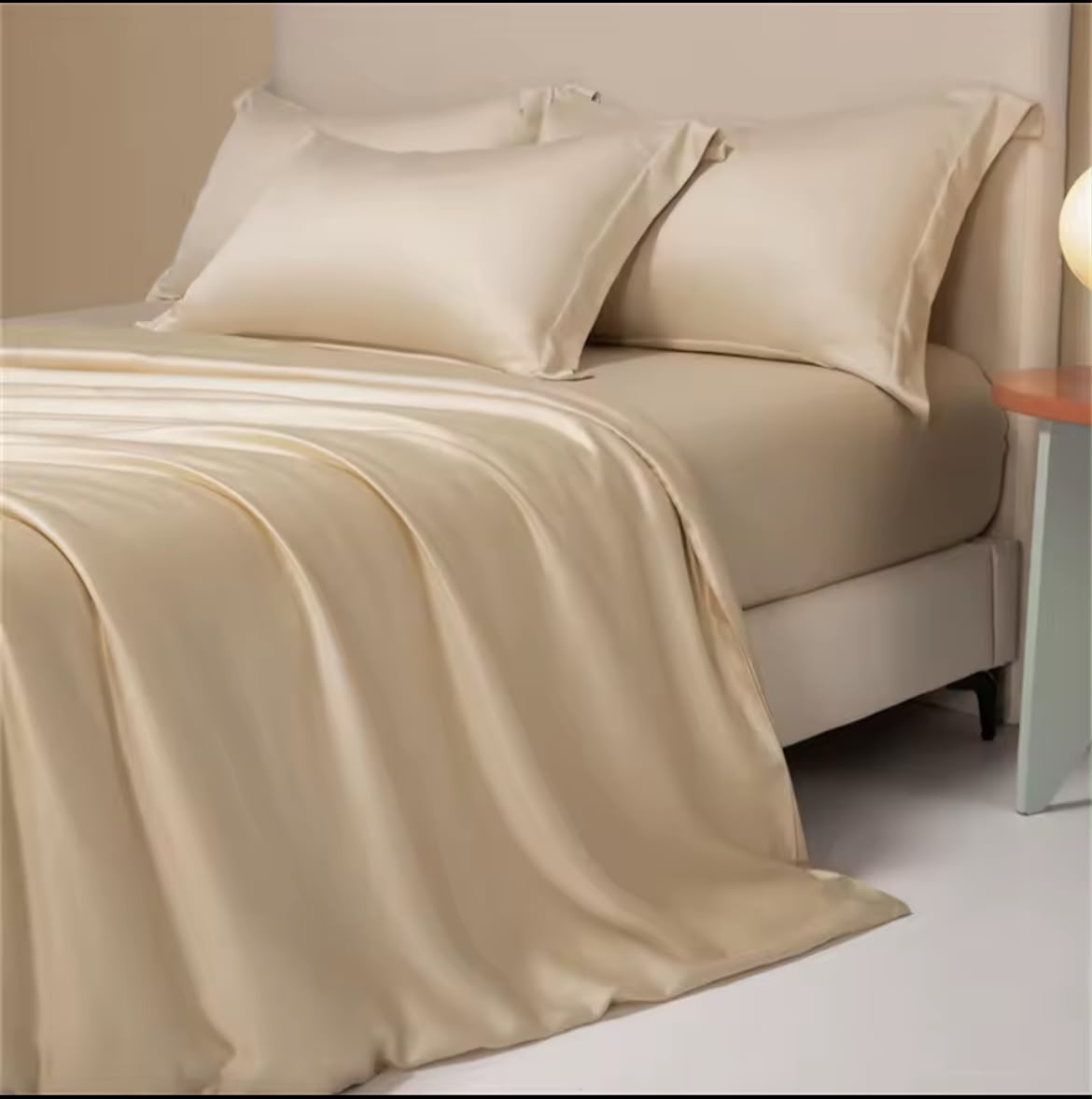 Champagne silk-touch duvet cover close-up showing pillowcases and sheet drape